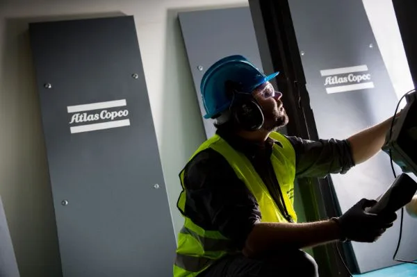 Service engineer during a service contract visit to an Atlas Copco air compressor